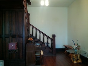 Entryway with piano, staircase and unique juniper furniture