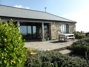 Rear of The Old Carthouse with terrace looking out to the sea and village.