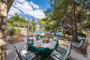 Ground floor terrace- dining under pine trees