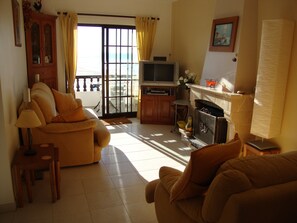 Open lounge to balcony and sea view with electric fire