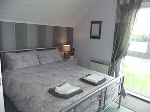 Master bedroom with king size bed and wonderful views of lake
