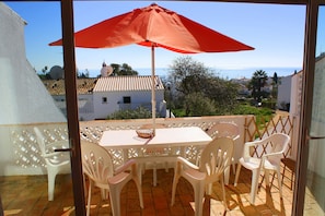 The lounge opens onto veranda with sea view and steps down to the pool area