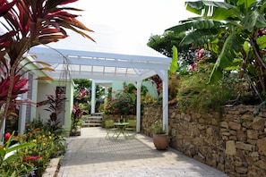 Rear gazebo surrounded by tropical plants