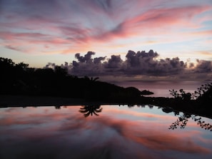 reflection in the infinity pool at sunset