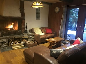 Sitting room with fire, logs provided. Patio doors open to deck with hot tub