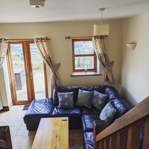 Woodland Barn is a converted stables and hayloft.  It is a split-level property with the living space (lounge and dining nook) on the ground floor with 6 steps leading up to the kitchen and bathroom and another 6 steps leading up to the bedroooms.