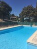 Pool set in the garden area with house in background background