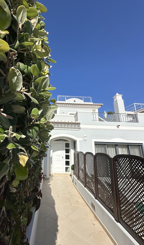 Villa Flores entrance & front door, approached via a few steps.
