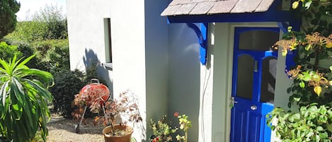 The attractive front door to Granary Cottage with BBQ nearby