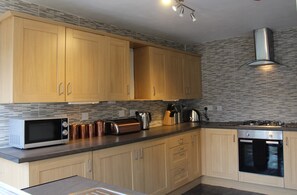 Kitchen with integrated fridge, freezer and dishwasher