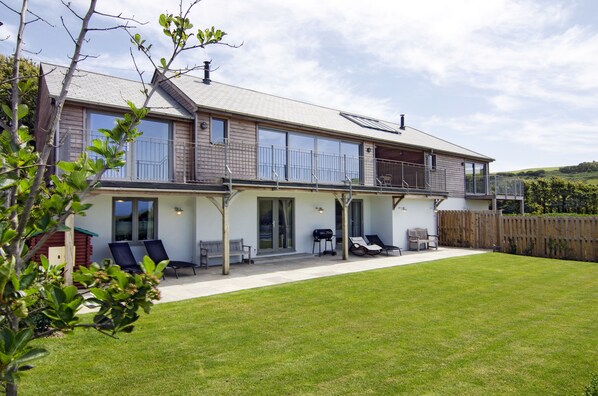 Back Garden with Wendy House, loungers, benches and bbq