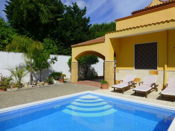 Roman steps rise up from the crystal clean waters of the private swimming pool.