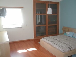 Main bedroom with air conditioning and TV