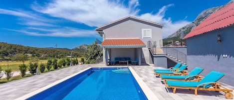 Pool area with covered poolside patio,4 sun chairs, BBQ and 36m2 private pool.