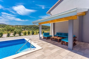 Pool area with covered poolside patio,4 sun chairs, BBQ and 36m2 private pool.