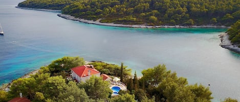 Aerial view of the house, pool with stunning panoramic view of Tri Luke bay