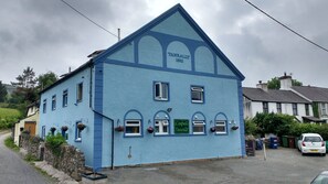 Capel Tanrallt with private parking to the front and side of the building.