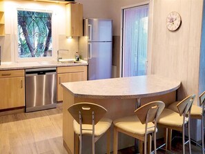 Fully equipped modern kitchen and breakfast bar for four guests