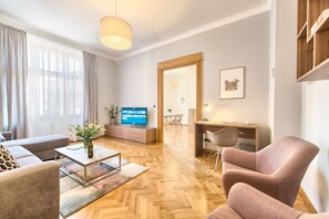 Cozy living room with comfortable sofa, Smart TV and a working space