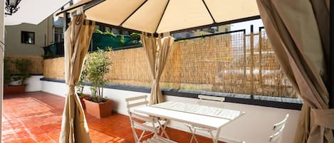 Large terrace, equipped with gazebo, beach umbrella, sunbeds, dining table.