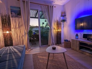 Unwind in this dreamy, ambient living space! Soft lighting, cozy textures, and a seamless flow to the outdoor lounge make it the perfect spot to relax.