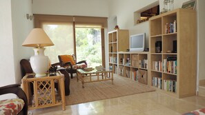 Living area looking out towards the garden and parking area of the villa.