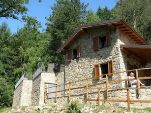 METATO AS SEEN FROM LIVING ROOM TERRACE. THE POOL IS ON THE RAISED AREA BEHIND