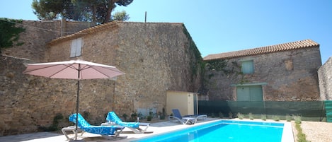 The pool is not overlooked, the barn is empty and part of the house