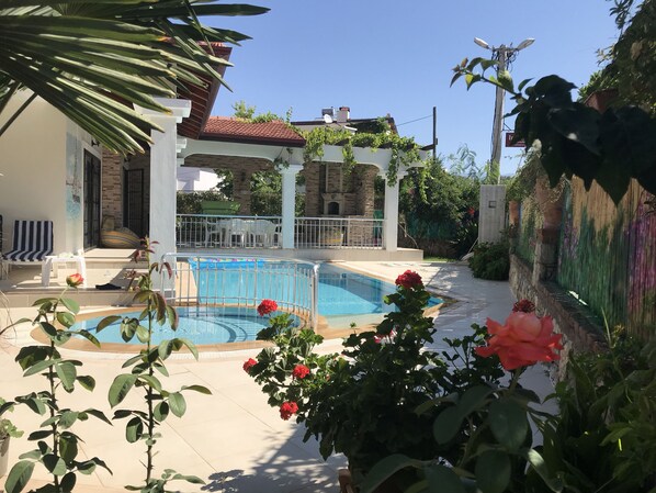 outside terrace and pool shielded from road by hand-painted bamboo fence