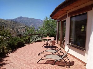 Relax on the ample sun terrace. The patio doors lead to the lounge.