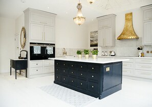 kitchen showing 2x ovens, hob and island