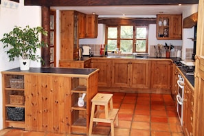 open plan kitchen with rayburn, cooker, fridge freezer, coffee machine