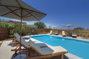 45 sq. m swimming pool, surrounded by sun beds & umbrellas