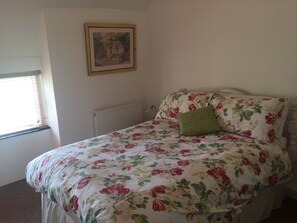 Double bedroom overlooking the green. 