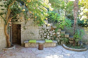 Details of the large and furnished garden packed with plants and flower.