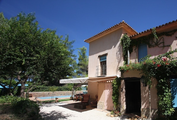 Side of house with pool in background