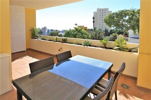 South facing balcony with outdoor dining area and sea views