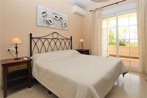 Master bedroom with king size bed and air conditioning