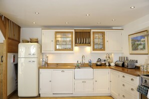 Kitchen with fridge freezer and sink with three way water filter tap