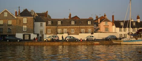 Front of Hannaford's Quay cottage from the estuary at high tide