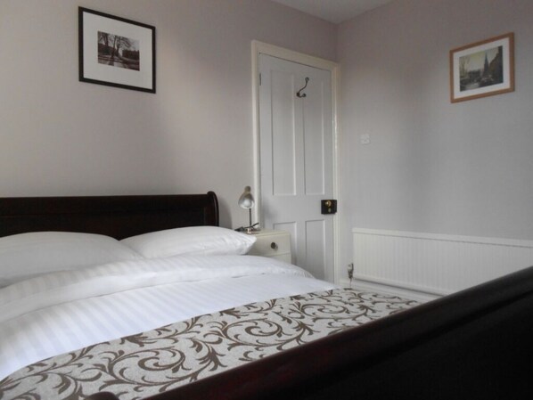 The second bedroom with standard mahogany sleigh bed.