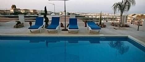 Relax by the pool with panoramic sea view