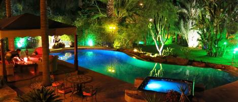 Stunning night time lighting around pool and garden