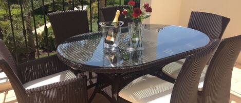 Al fresco dining area overlooking gardens and pool