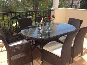 Al fresco dining area overlooking gardens and pool