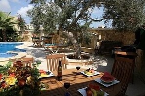 an 8 seated table under a bamboo canopy