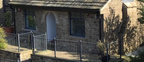 Another view of cottage front showing small parking area to front