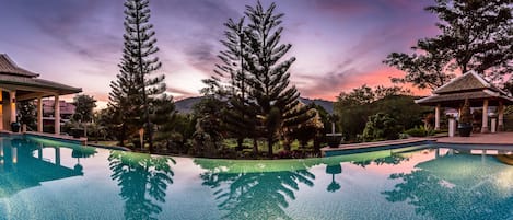 Main Pool (17M) with ample space or fun, dining and sunset views over mountains.