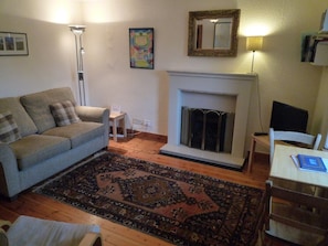 Living room with double sofa bed with dining area