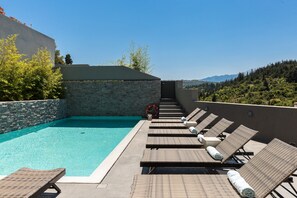 Private pool area surrounded by sun beds